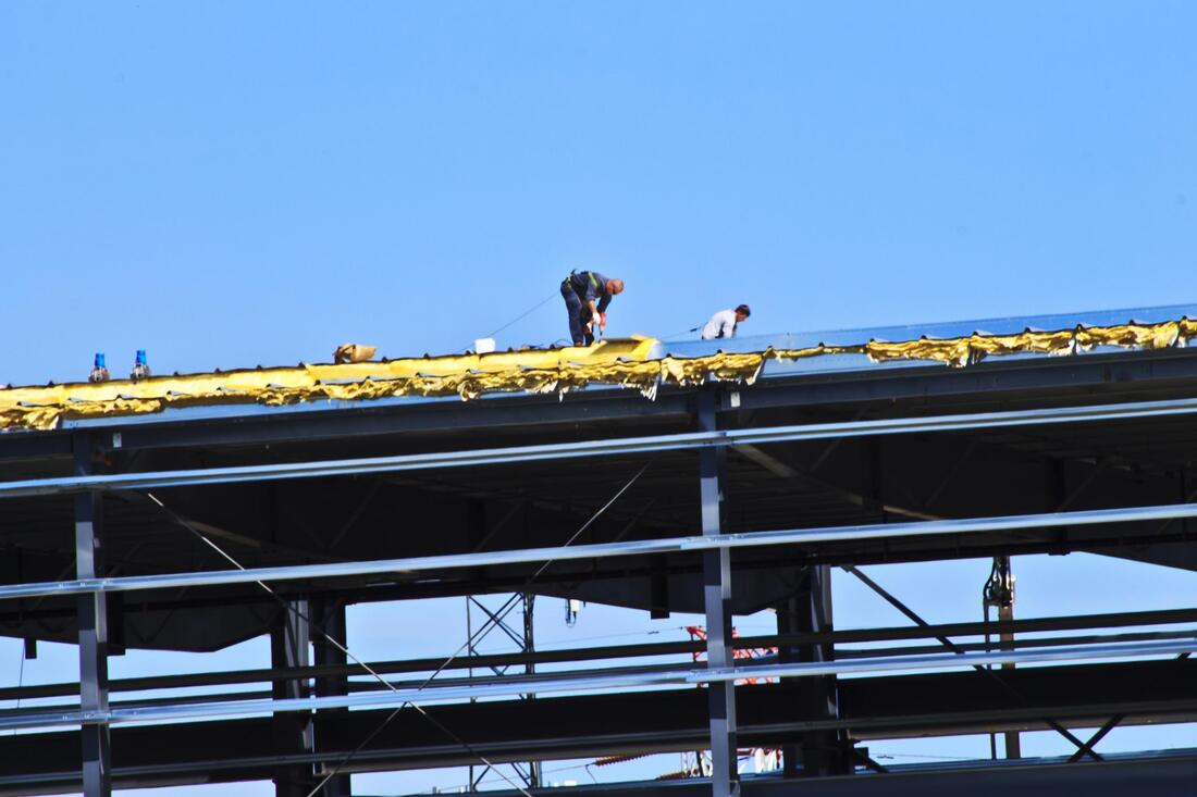 workers repairing the roof
