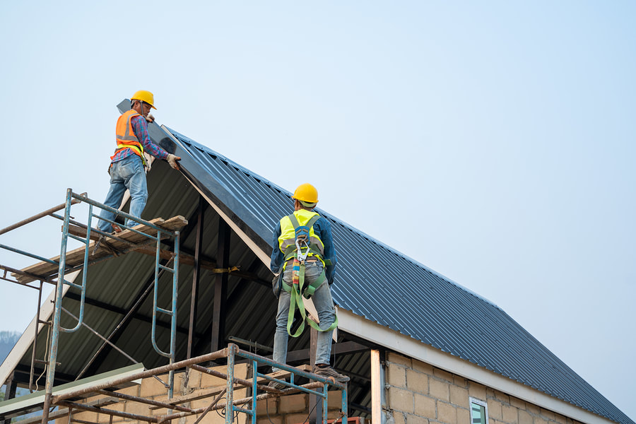 workers repairing the metal roof