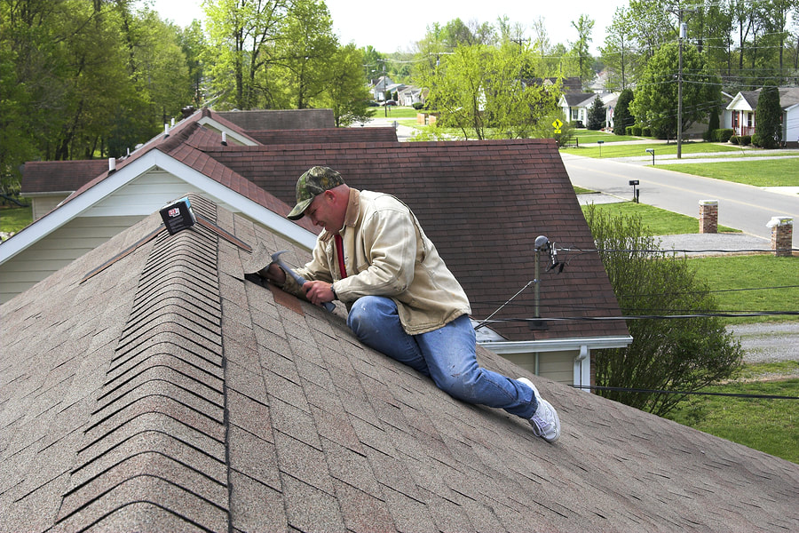 man hammering the roof